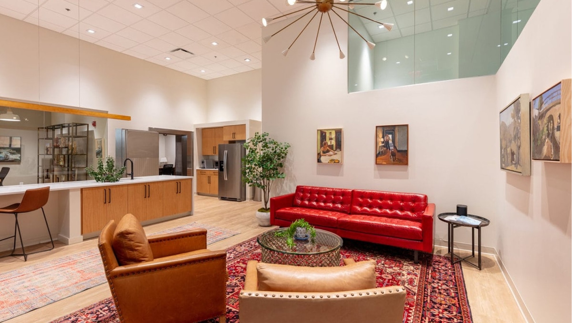 Gallery360 interior with a red sofa and paintings on the walls